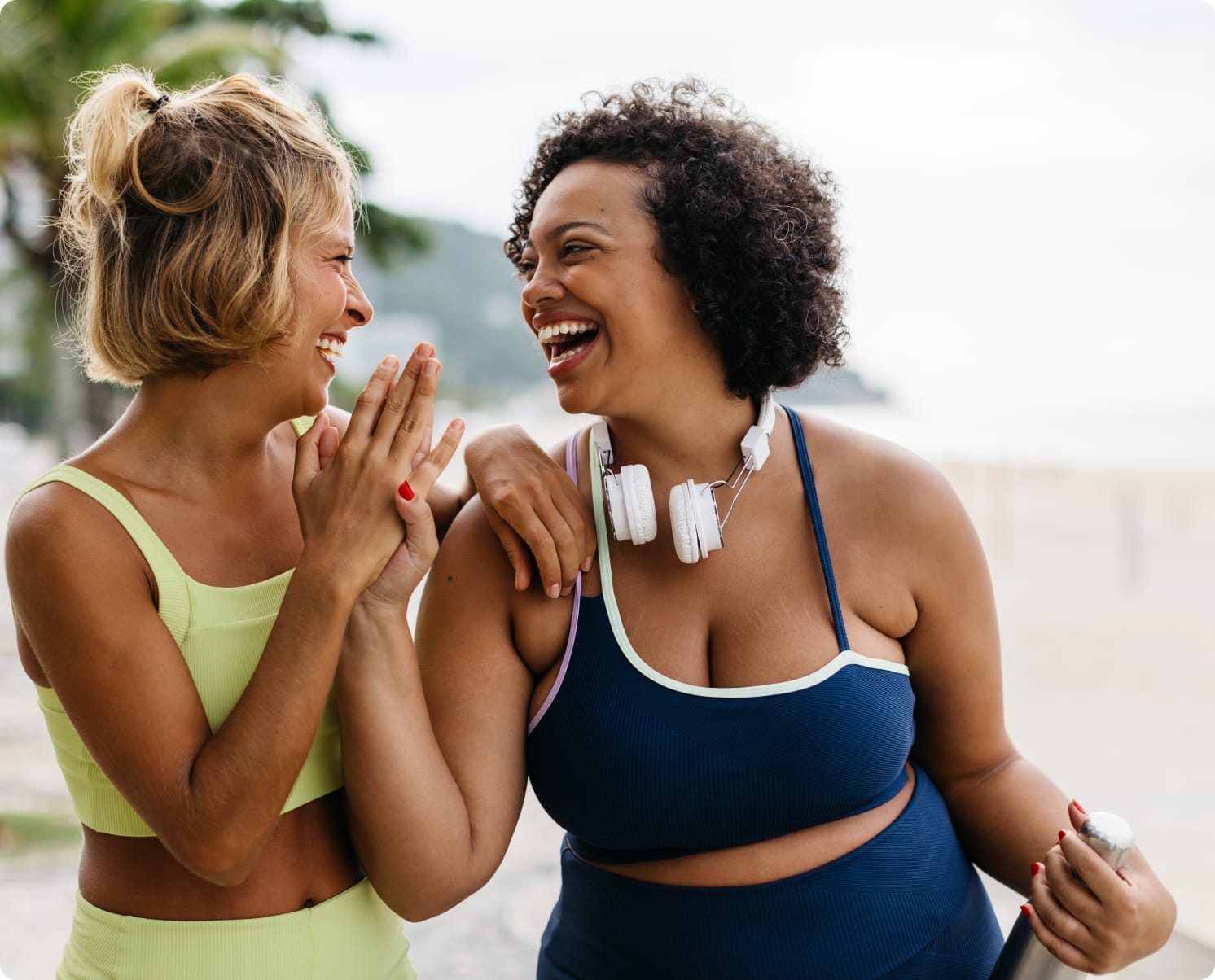 Two women in workout clothes, laughing