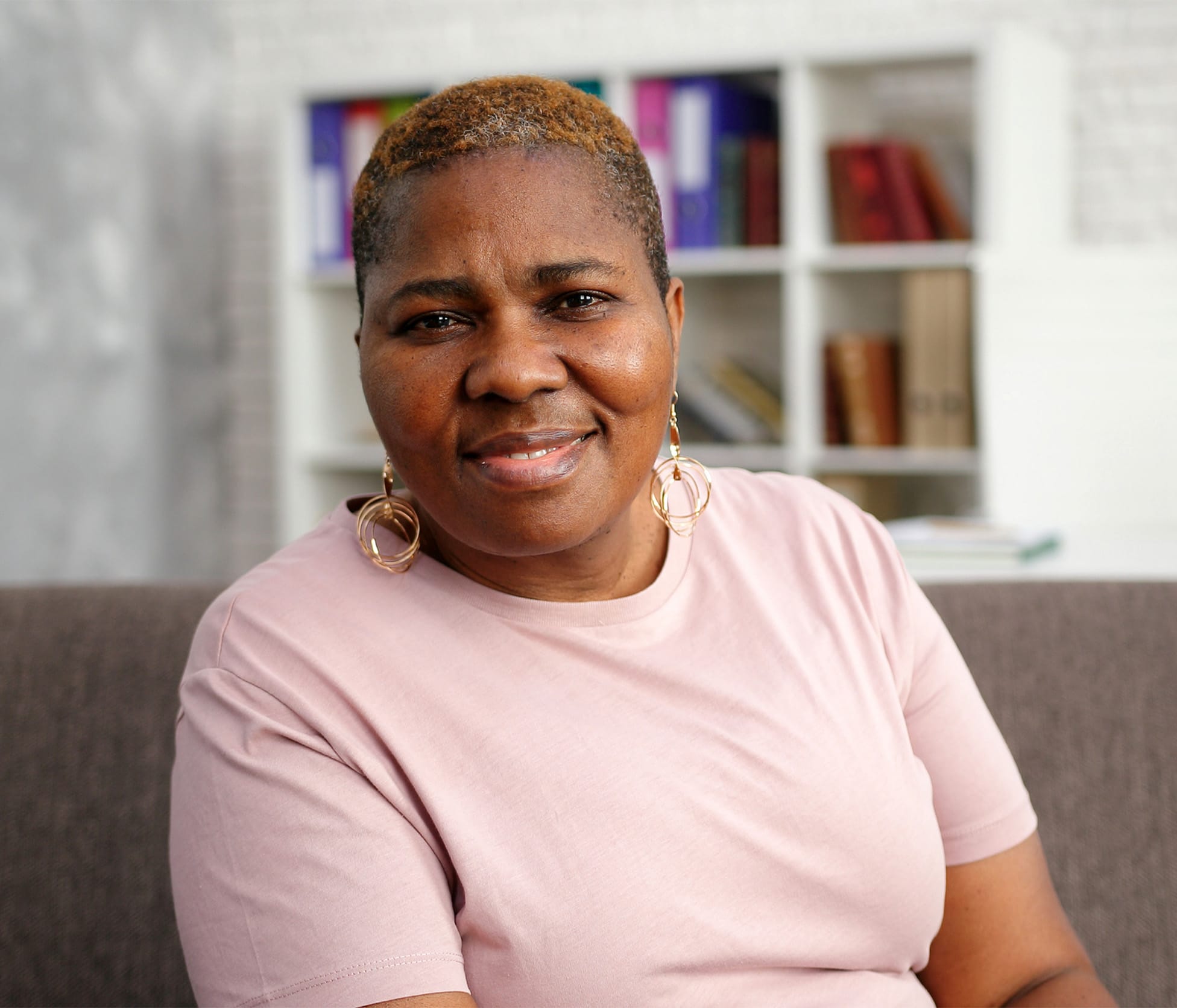 Woman smiling and sitting on couch