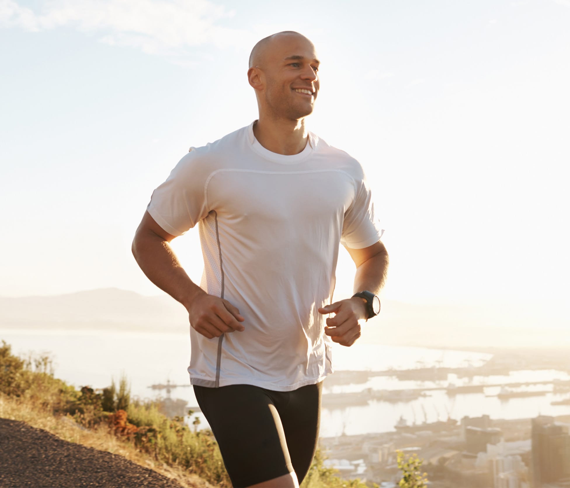 Man smiling and jogging