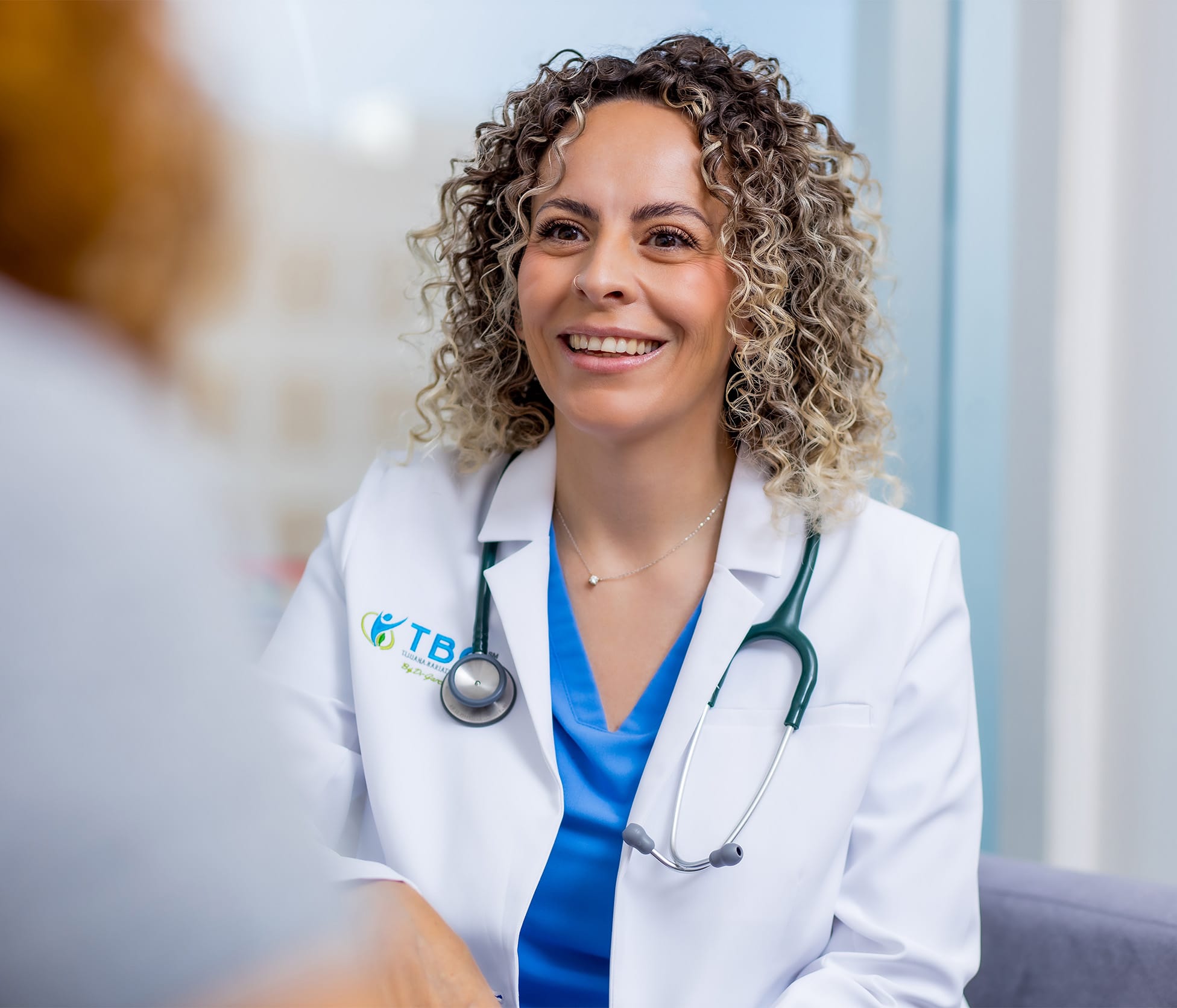 Doctor smiling and speaking with patient