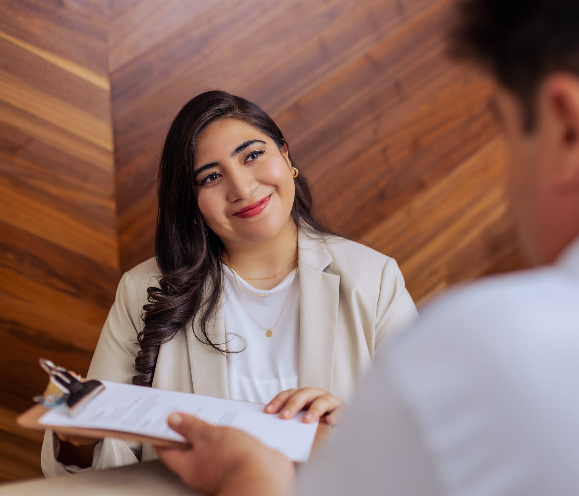 Tijuana Bariatric Center Staff member smiling and handing over clip board to patient