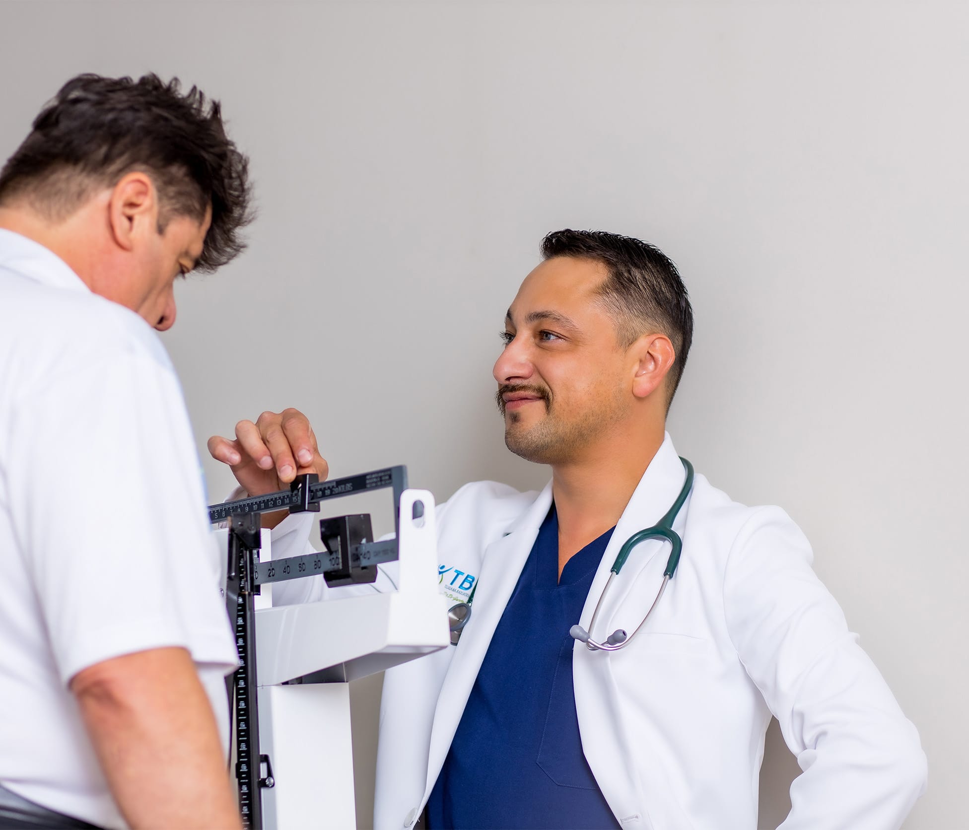 Dr. Jose Luna Checking patient's weight