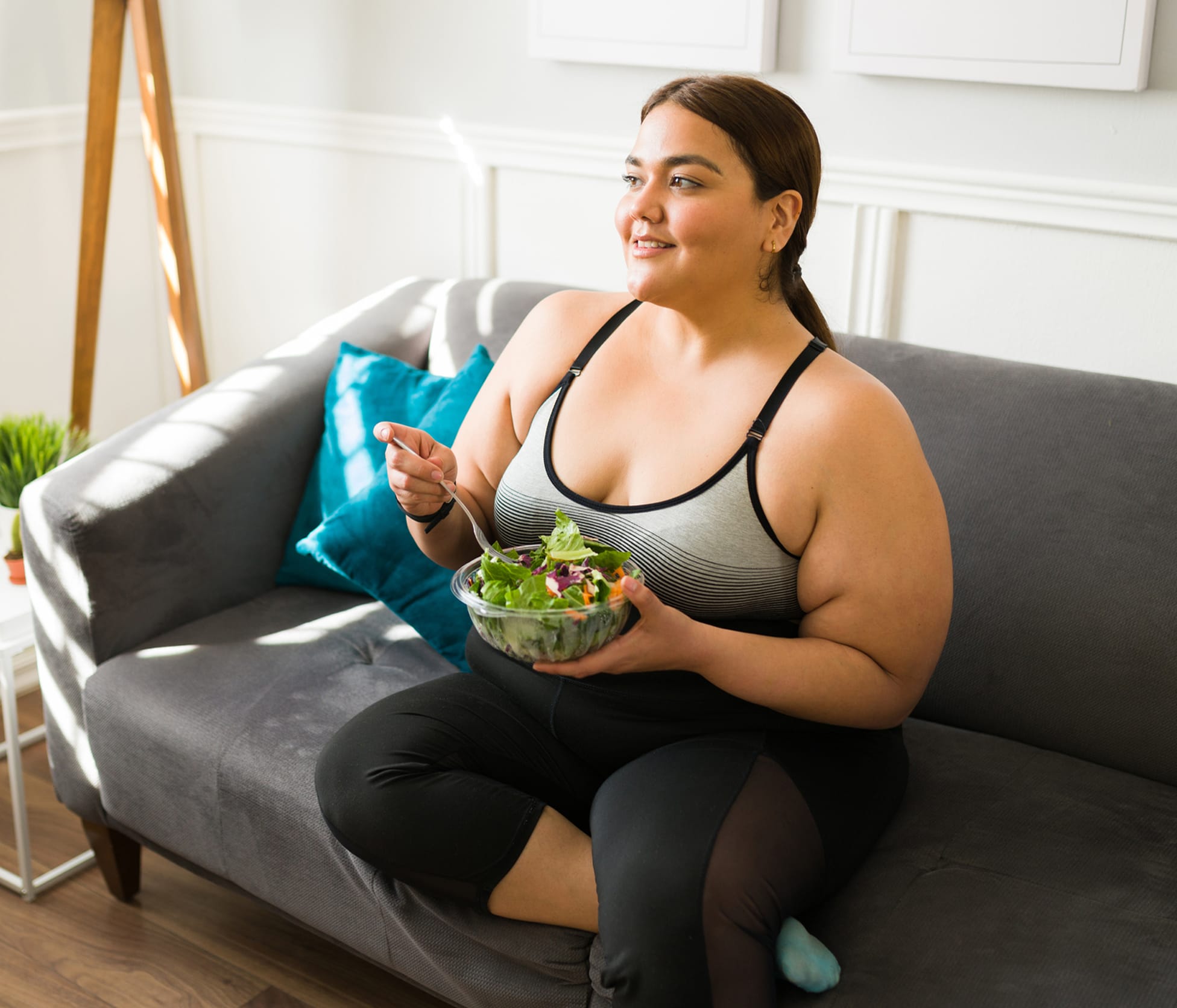 Woman Smiling and eating salad