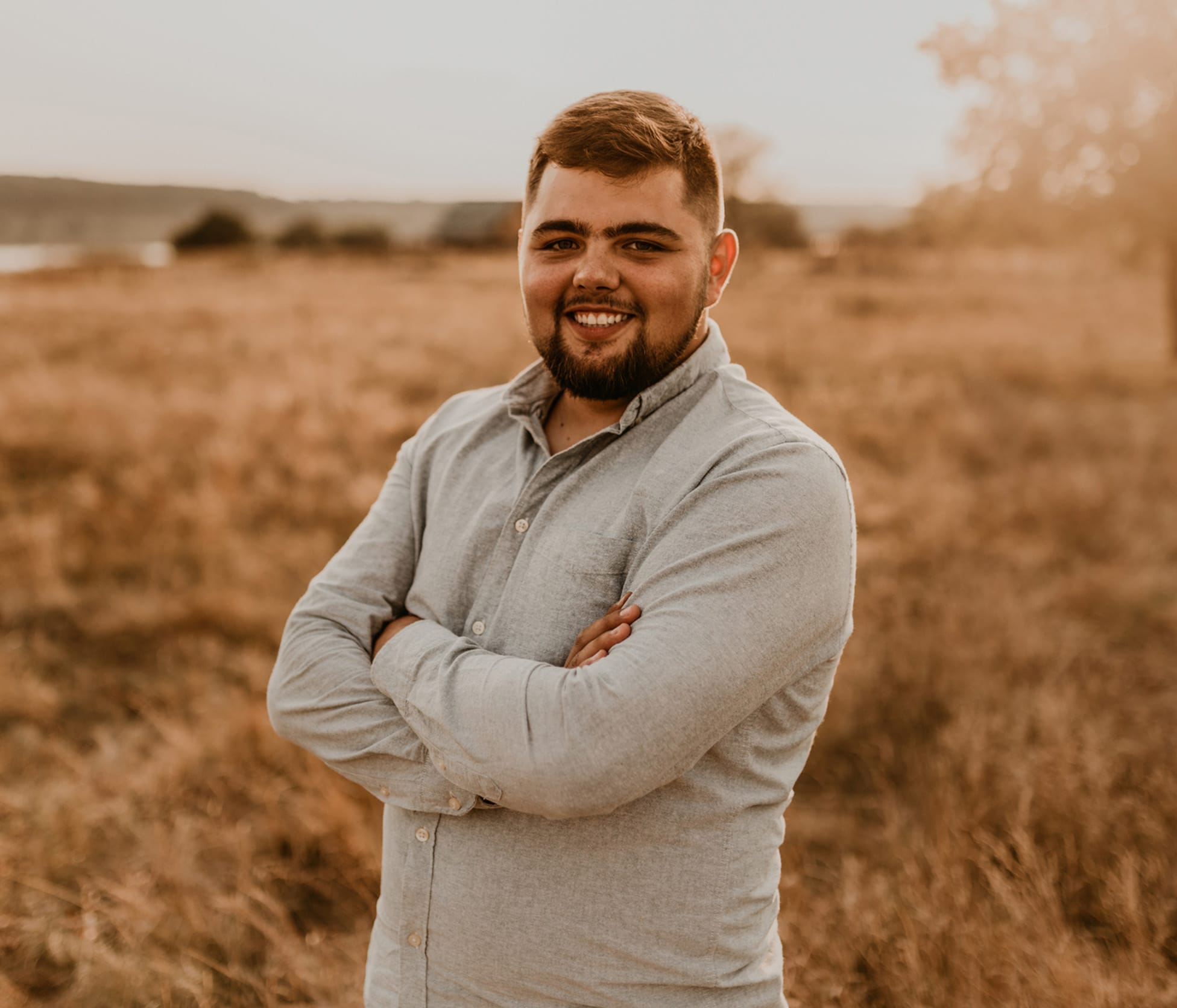 Man smiling with arms crossed