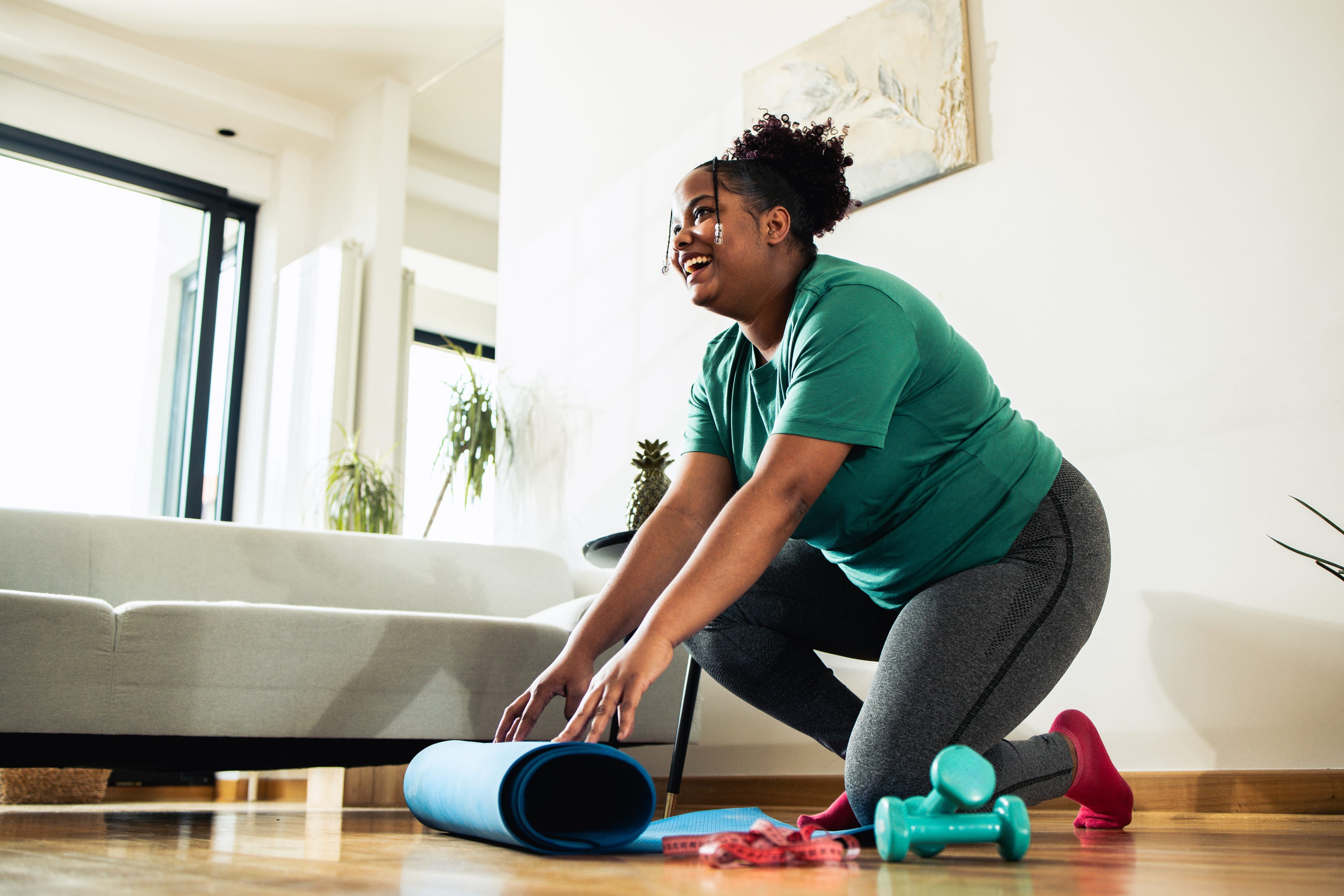 Woman setting up yoga mat