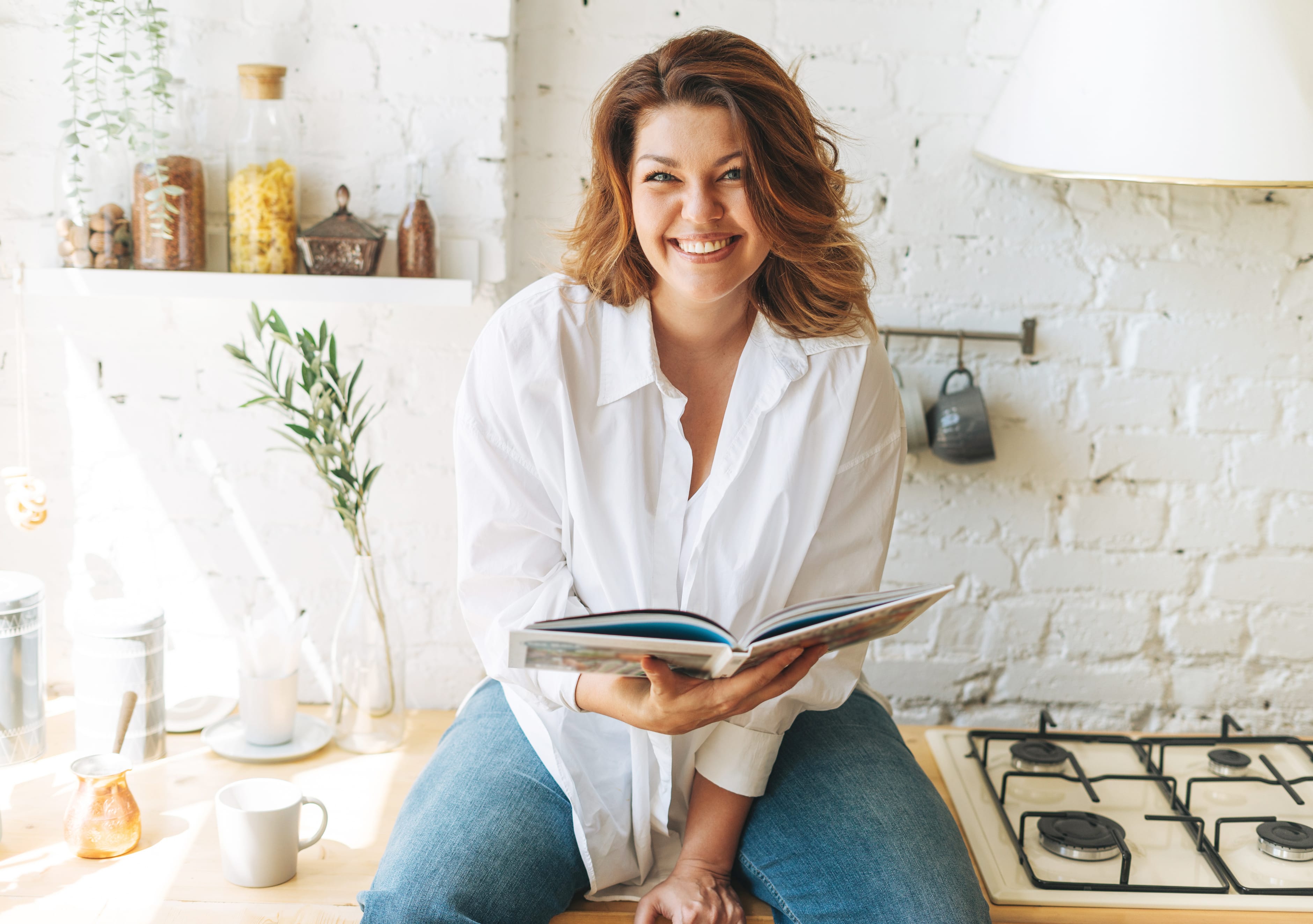 Woman in white blouse reading a book